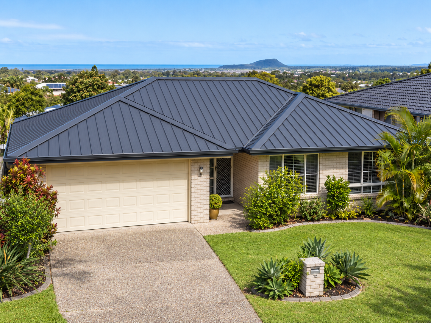 After roofing project with modern charcoal metal roof