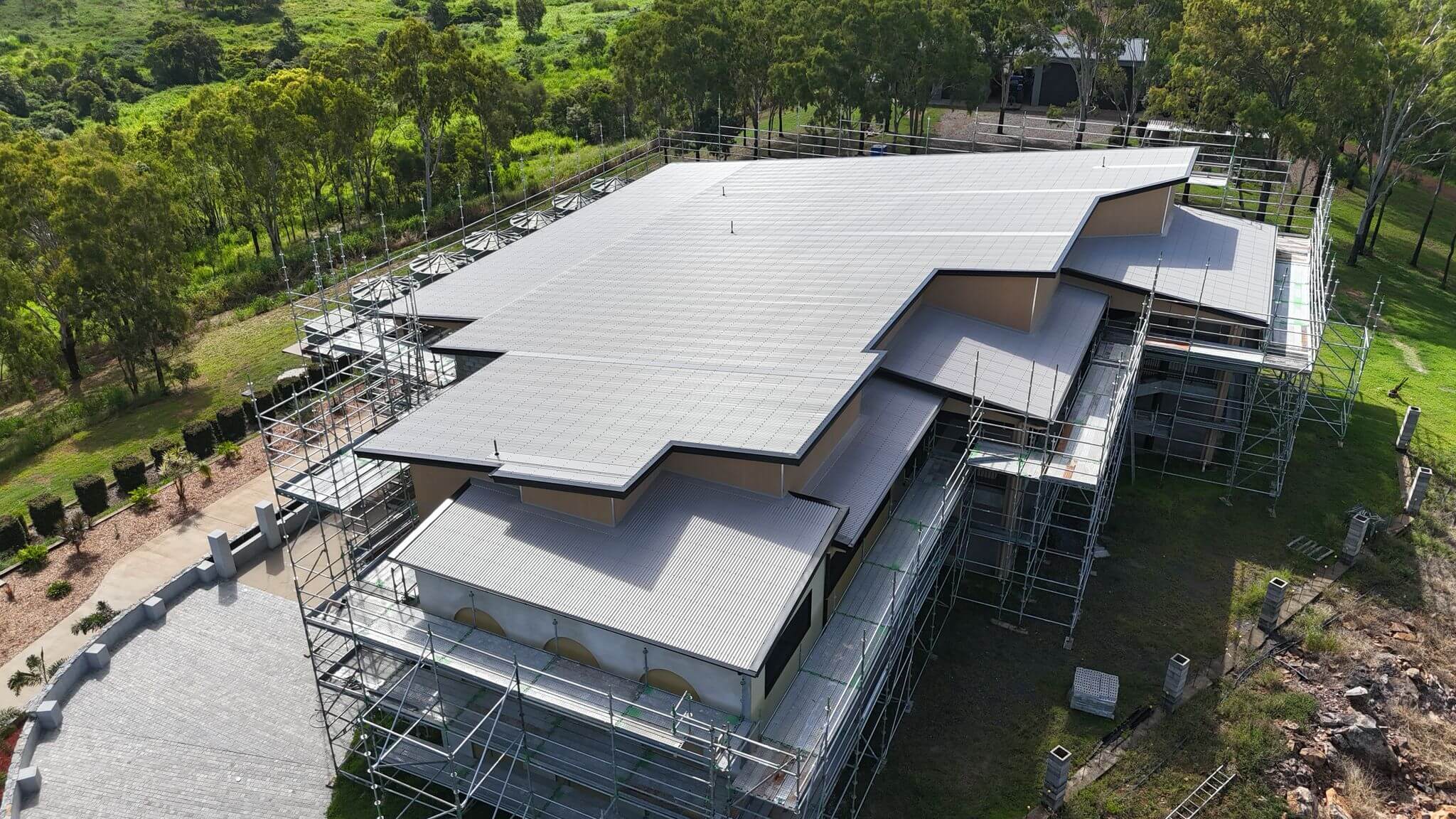 Actual Heavy Metal Roofing project photograph showing a metal roof and perimeter scaffolding